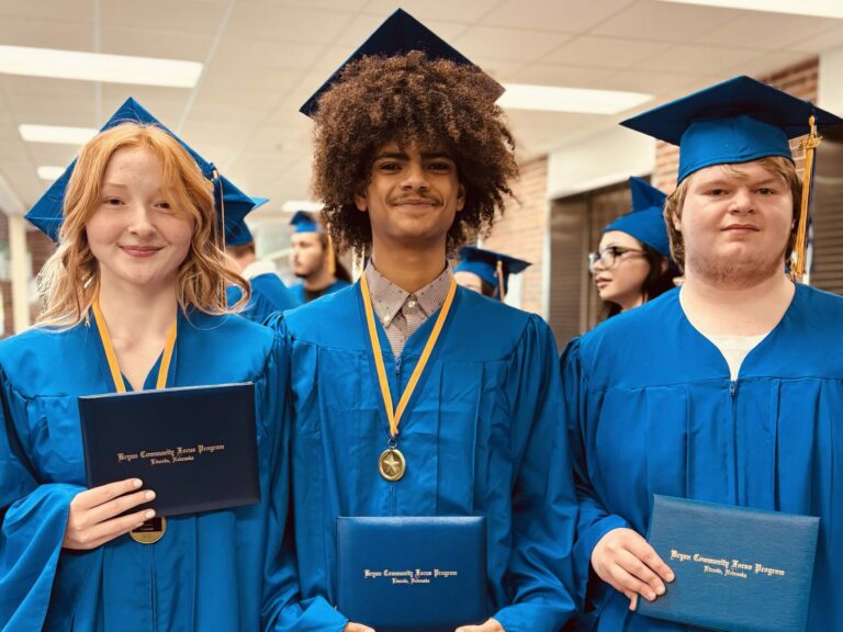 Three Bryan students with their diplomas